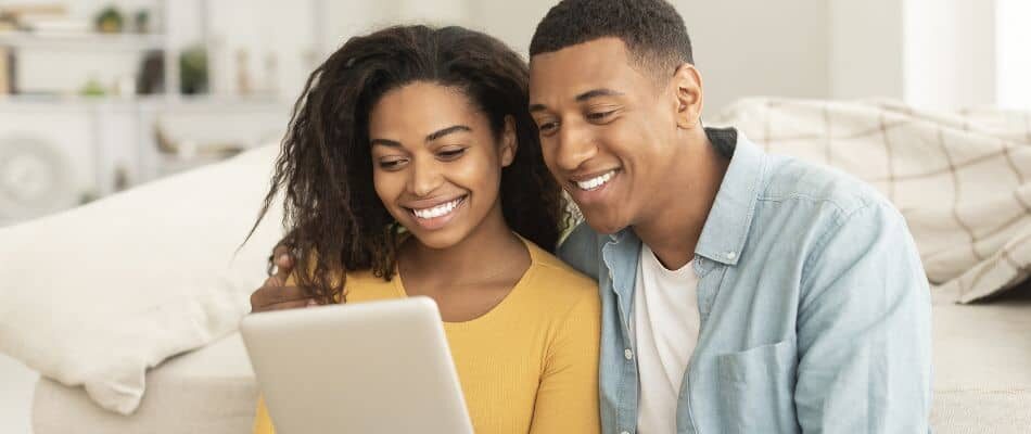 Young Couple Looking At Tablet